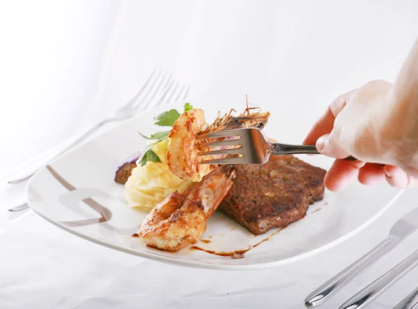 Shrimp on fork over a mix food background — Stock Photo, Image