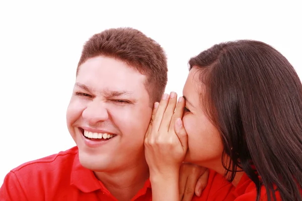 Woman telling a man a secret - surprise and fun faces - over a w — Stock Photo, Image
