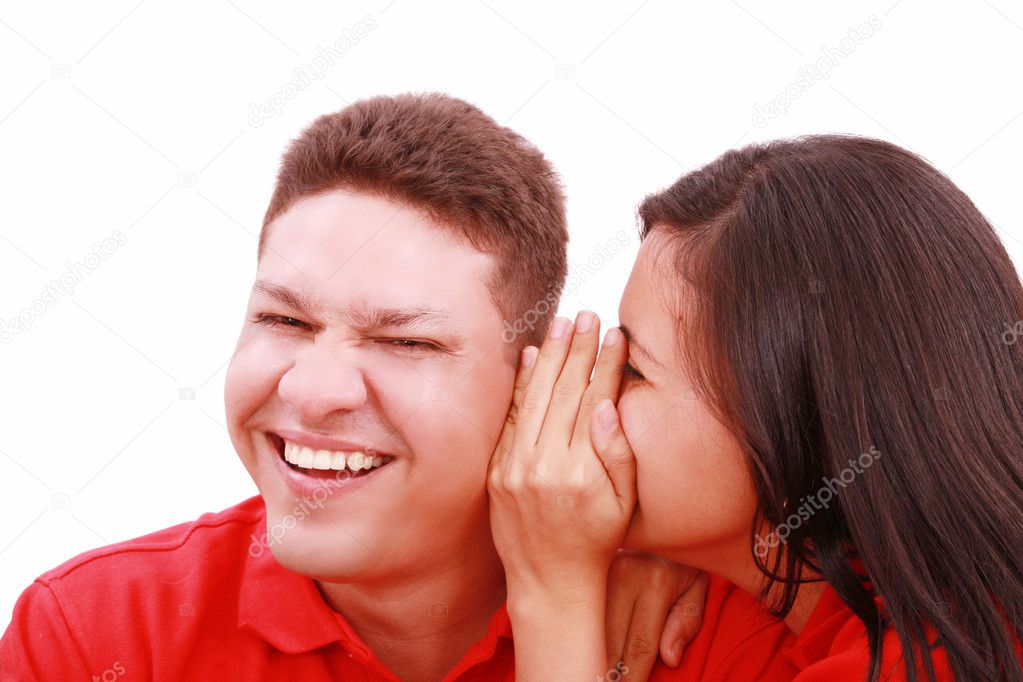 Woman telling a man a secret - surprise and fun faces - over a w