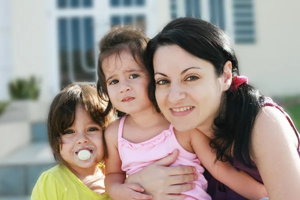 Mother and Daughters portrait outdoors in front of their home — Stock Photo, Image
