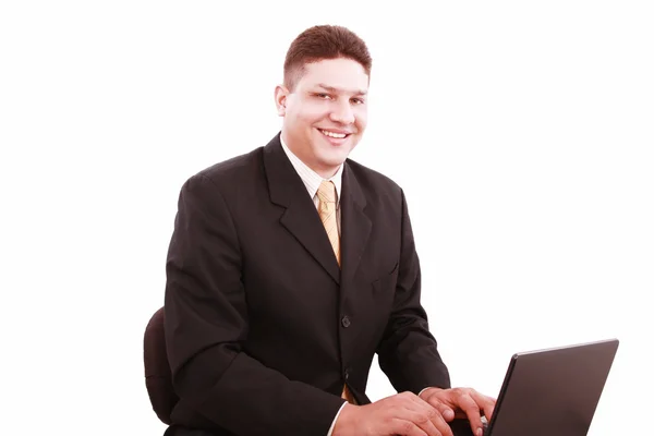 Portrait of businessman in front of laptop computer — Stock Photo, Image