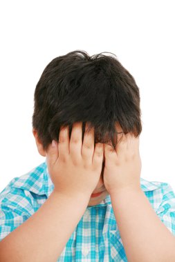 Very cute little boy with sad expression and hands on face clipart