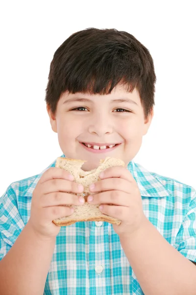 Malý chlapec jíst integrální chleba, sendvič. izolované na prostřené — Stock fotografie