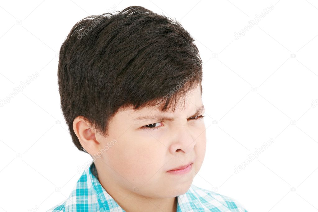 Close-up portrait of angry little boy isolated on white backgrou