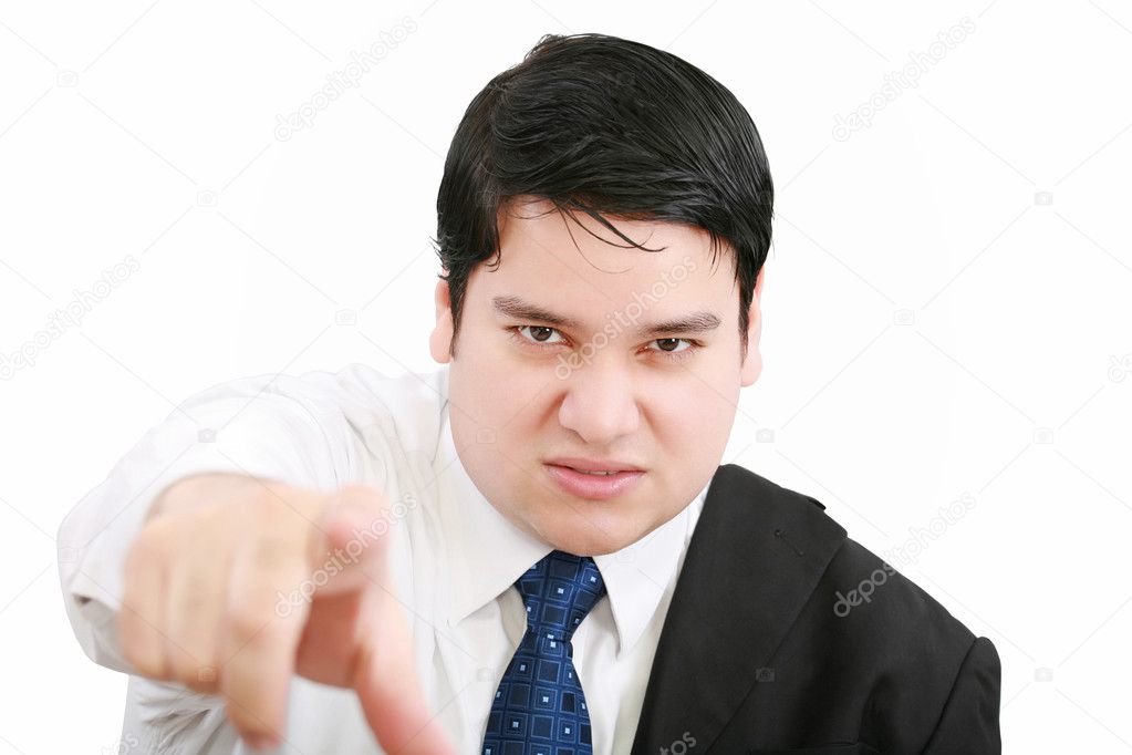 Portrait of an angry young business man in suit pointing at you