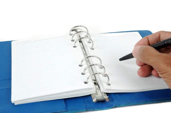 Male hand writing at blue leather notebook — Stock Photo, Image