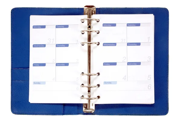 Um caderno de couro azul aberto com papel semanal — Fotografia de Stock
