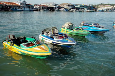 Four speedboats are anchored clipart
