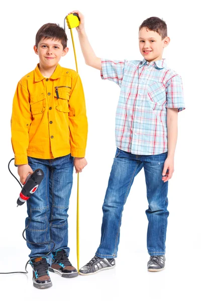 Two cute boys with tape and a drill. — Stock Photo, Image