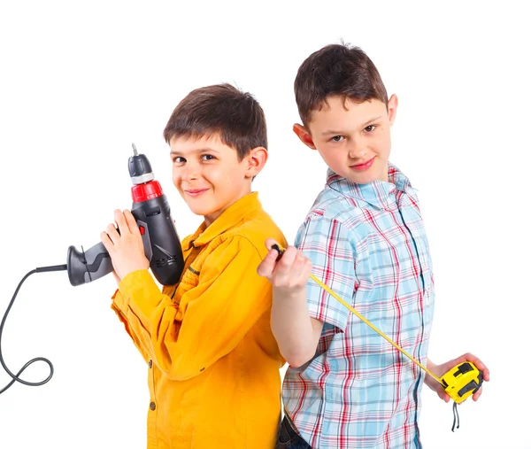 Two cute boys with tape and a drill. — Stock Photo, Image