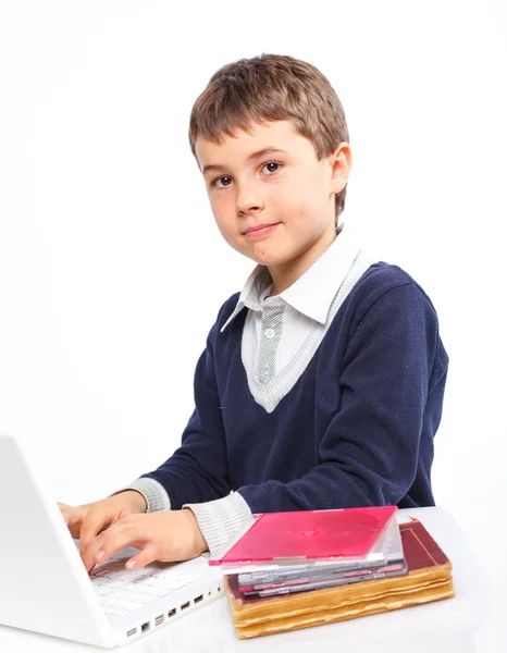 Boy learning with his books and laptop. — Stockfoto