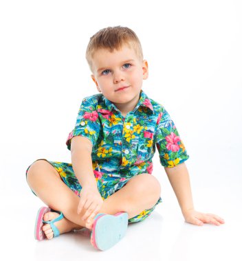 Little cute boy dressed in beach clothes clipart
