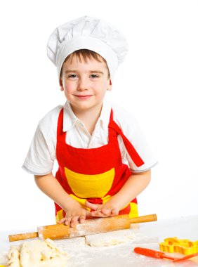 Beautiful caucasian boy making a cake clipart