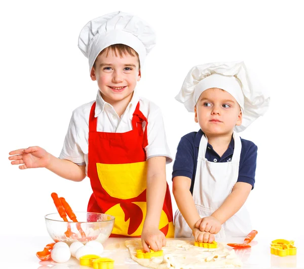 Two beautiful caucasian brothers making a cake — Stock Photo, Image