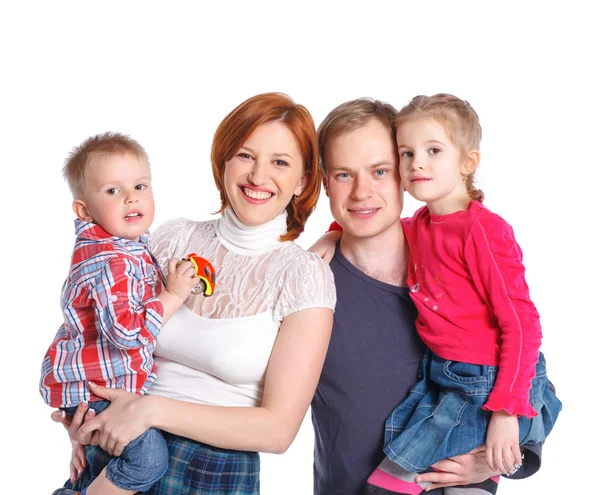 Famiglia felice sorridente alla macchina fotografica — Foto Stock