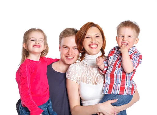 Happy family smiling at the camera — Stock Photo, Image