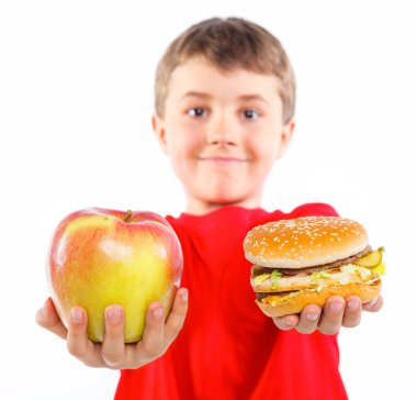 Boy eating a hamburger. clipart