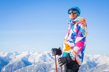 Young man with skis and a ski wear