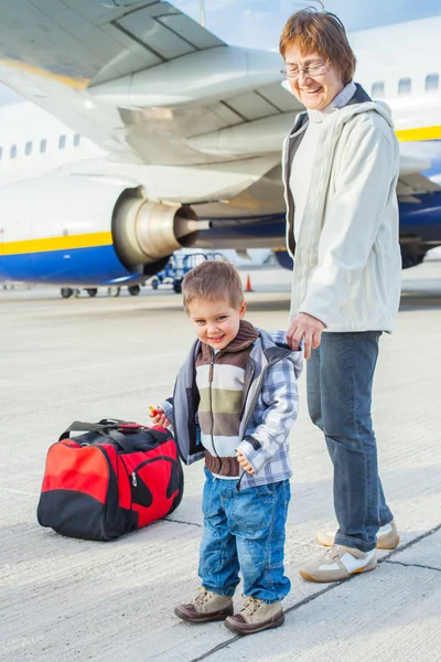 Cute boy and his grandmother prepared to fly — Stock Photo, Image