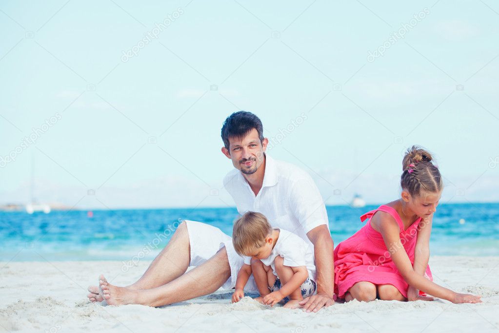 Cute father and her child playing at beach