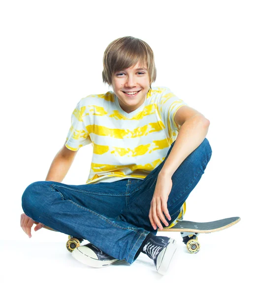 Blond boy on sitting on skateboard — Stock Photo, Image