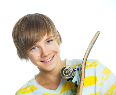 Blond boy on standing on skateboard clipart