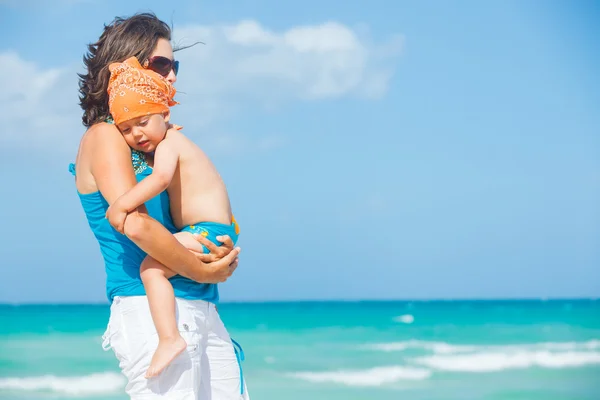 Cute little boy and his mother at beach — Stock Photo, Image