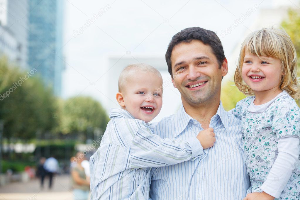 Man walking in city park with child