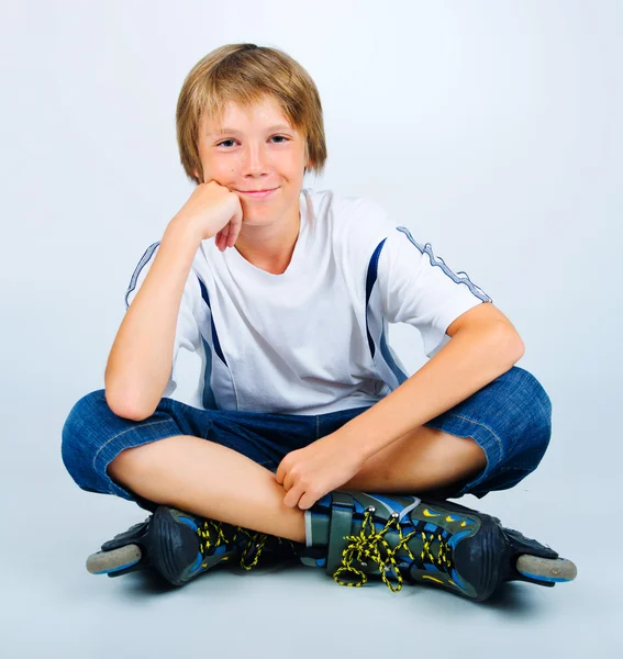 Portrait of young beautiful boy roller skating — Stock Photo, Image