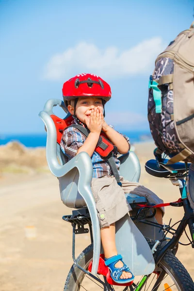 Child sitting by bicycle in crash helmet — Stock Photo, Image
