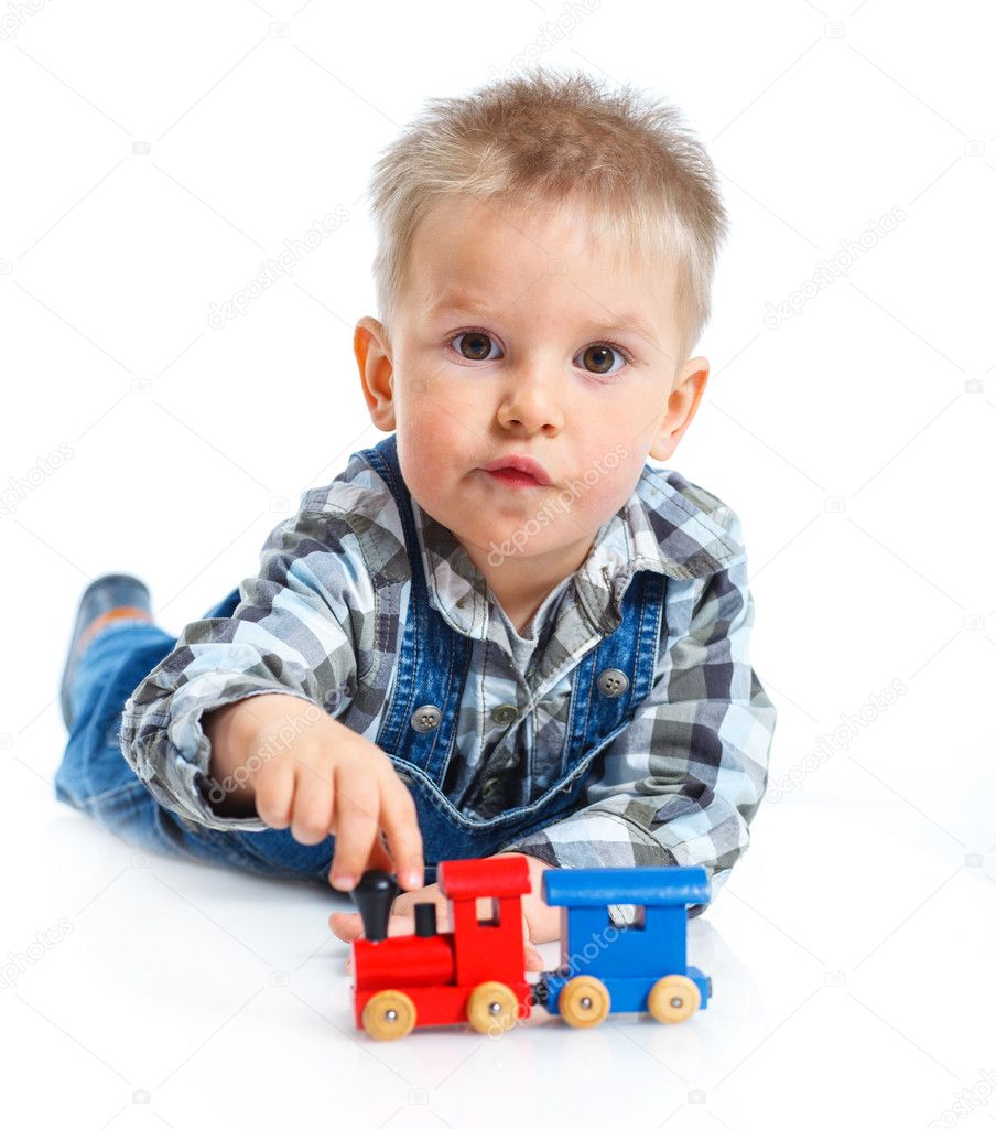 Cute little boy playing trains