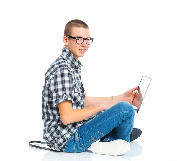 Seated young man using a laptop — Stock Photo, Image