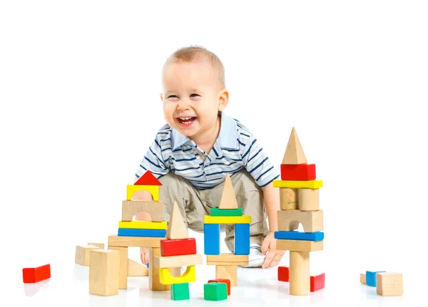 Smiling little boy is building Royalty Free Stock Images