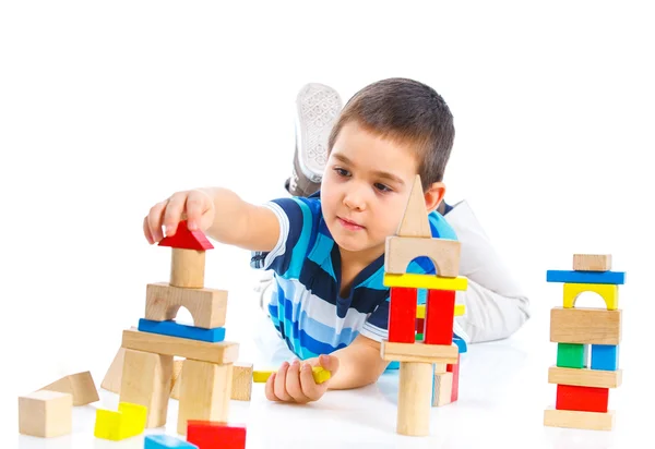 Smiling little boy is building Royalty Free Stock Images