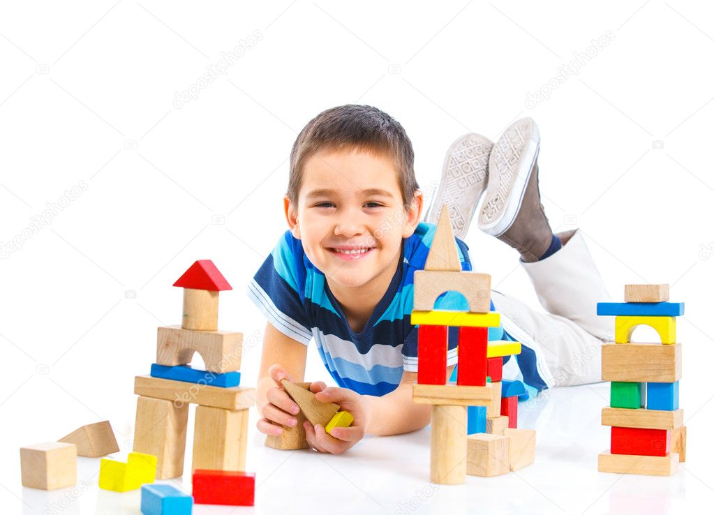 Smiling little boy is building