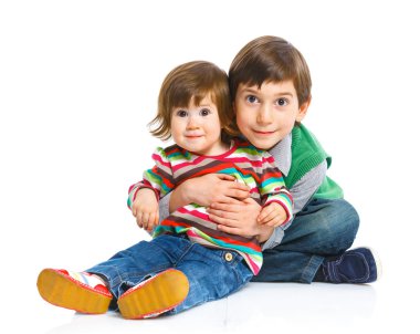 Smiling young brother and sister in a hug clipart