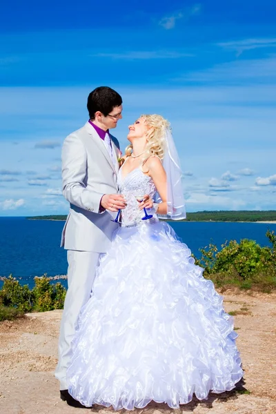 Happy groom and bride on a sea coast — Stock Photo, Image