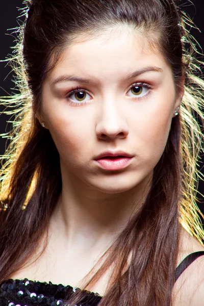 Beautiful teenager girl with long dark hair on black — Stock Photo, Image