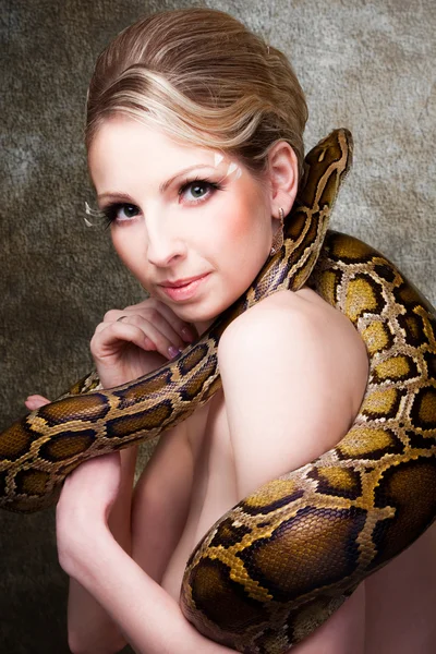 Attractive nude blond woman with python on grey — Stock Photo, Image