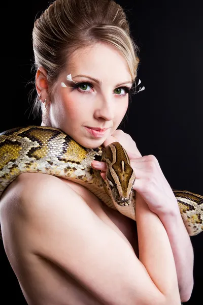 Attractive nude blond woman with python on black — Stock Photo, Image