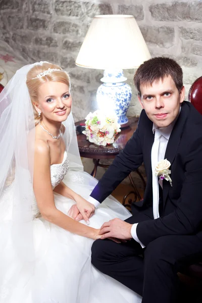 Beautiful groom and bride in interior — Stock Photo, Image