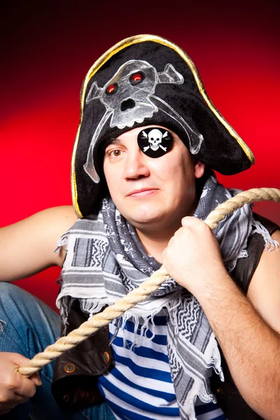 One-eyed pirate with a cocked hat and a rope