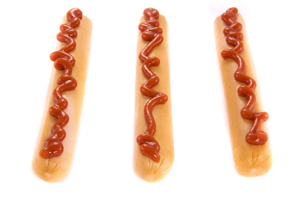 Três salsichas com ketchup — Fotografia de Stock