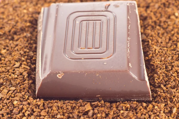 Chocolate on coffee powder — Stock Photo, Image