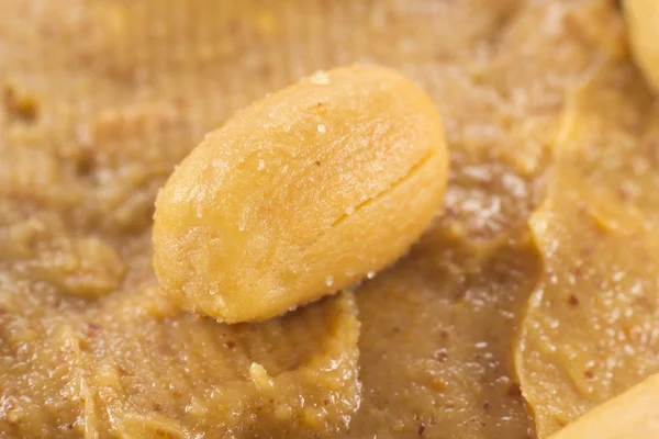 Closeup of a peanut on peanut butter — Stock Photo, Image