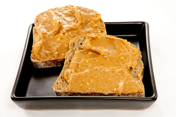 Fatias de pão com manteiga de amendoim — Fotografia de Stock