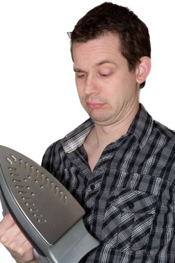 Man looking on a iron and wondering clipart