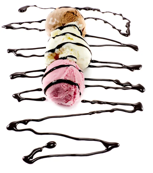 Tricolor scoops on a row with melted chocolate lines — Stock Photo, Image