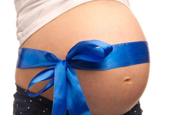 若い妊婦の腹部はブルーのリボン、 — ストック写真