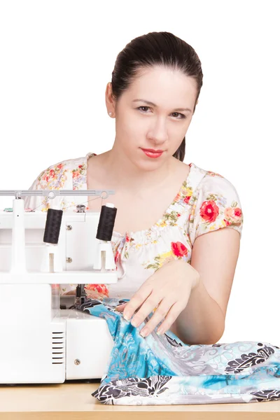 stock image Woman in summer blouse darning on the sewing machine